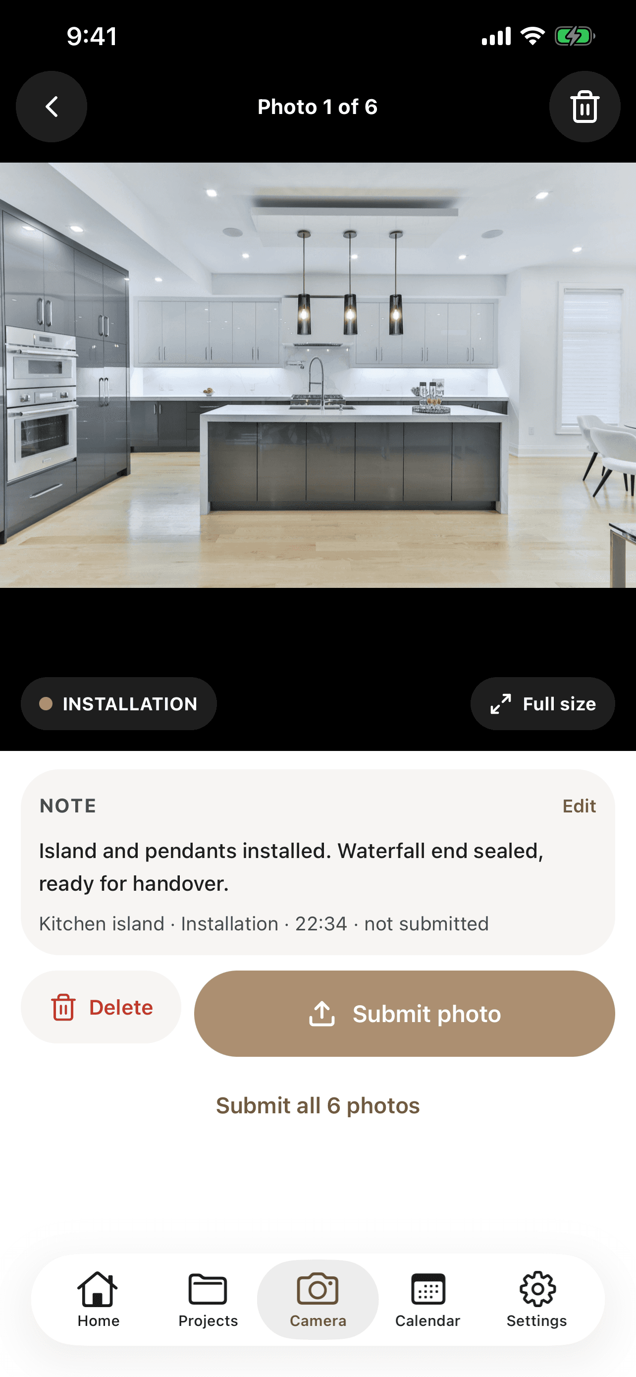 CabiPro camera screen on iPhone previewing an installed kitchen island photo, with a note attached and a submit photo button.